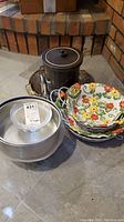 Photo showing grouped items including plastic ice bucket, metal cake tins, Grillmate thermometer, metal tray, and two floral ceramic serving dishes with carriers