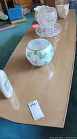 Full length view of the coffee table showing the smooth wooden surface with a few decorative objects on top and a lot tag (512).