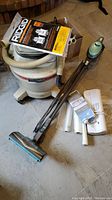 Main view showing Craftsman wet-dry vacuum with hose and attachments, Shark Rocket vacuum cleaner with extension wand, vacuum nozzle and filters along with other accessories.