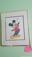 Framed print of Mickey Mouse waving, showing colors and condition.