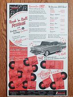 Close-up detail shot of the hardboard sign with visible printed text and 1957 Chevrolet Belair image