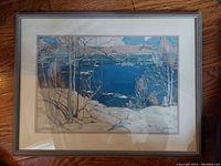 Full front view of framed landscape print under glass, showing trees, rock, and lake scene.