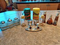 Photo showing six sets of vintage and collectible salt and pepper shakers arranged on a kitchen counter.
