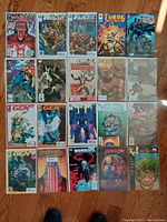 Full view of all twenty vintage comic books arranged on floor, showing covers and titles.