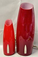 Front view of both red glass lamps side by side on white background