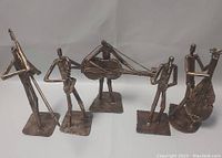 Front view of the 5 metal musical figurines showing different instruments