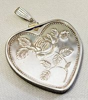 Front side of heart-shaped pendant with embossed rose design