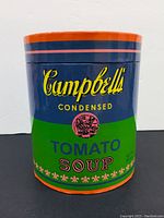 Photo of the cylindrical puzzle box resembling Campbell's Soup can artwork showing logo and color scheme