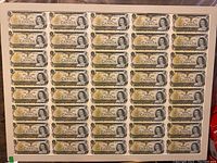 Full sheet view showing uncut banknotes in eight columns by six rows
