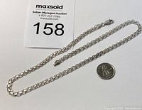 Full view of the sterling silver chain necklace next to a Canadian dime for scale and auction lot tag.