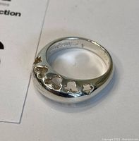 Close-up photo showing the sterling silver ring with Mickey Mouse head cut-outs and star shape.