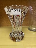 Photo of the cut crystal vase with LOT 271 sticker, showing scalloped rim and chopped geometric base pattern