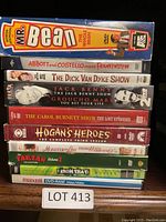 Photo shows 9 DVD cases stacked, titles visible.