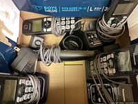 Panasonic cordless phones with cords wrapped around and charging docks plus power adapters in a box