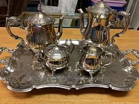 Full view of the silverplate tea service on the tray showing all five items together including teapot, coffee pot, sugar bowl, creamer, and tray.