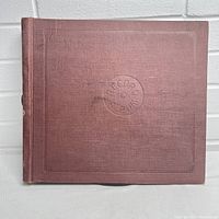 Front view of brown textured binder with embossed design and circular logo on cover