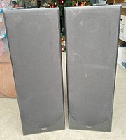 Front view of the pair of black Acoustic Profiles RMS-3500 speakers with fabric grills in place