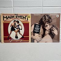 Two vinyl record albums side by side: The Main Event and A Star is Born