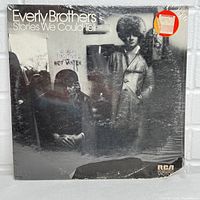 Front cover of the Everly Brothers Stories We Could Tell vinyl album, showing the artists in a black and white photo, sealed with some visible wear at the bottom corner.