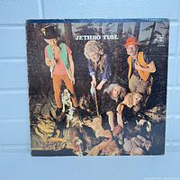 Front cover of Jethro Tull This Was vinyl album with band members and dogs.