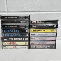 Front view of 14 Elvis Presley cassette tapes stacked in two columns showing titles and labels clearly.