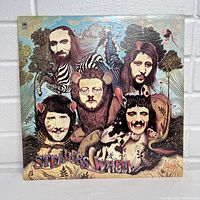 Front cover of Stealers Wheel vinyl album showing artistic caricatures of band members with animal and jungle theme.