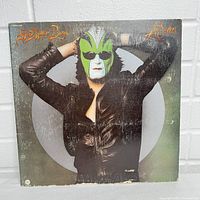 Front album cover of The Joker featuring man in leather jacket and green white mask