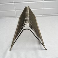 Front view down the side of vintage metal wire 45 RPM record holder, showing triangular shape and wire slots for records