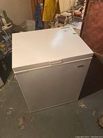 White Kenmore chest freezer with lid closed showing front and top sides.