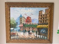 Full view of the framed oil painting showing the Moulin Rouge scene, street scene with pedestrians, buildings, and sky.
