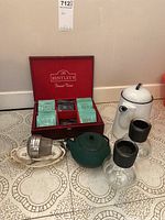 Full lot shown with box of tea bags, two teapots, two infusers, and serving dish.