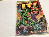 Front cover of Astonishing Tales #24 comic book showing cover art of The Living Colossus fighting a green monster with title and pricing information.