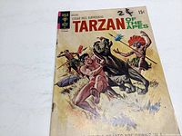 Front cover of Tarzan comic book #205 showing Tarzan fighting an ape, title and 15 cent price visible.