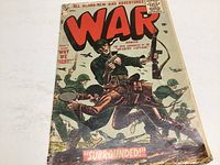 Front cover of War Comics Issue #38 November 1955 showing active combat scene with soldiers and aircraft, with visible wear and edge damage.