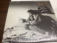 Front cover of Billy Joel The Stranger vinyl LP with shrink wrap and promotional sticker.