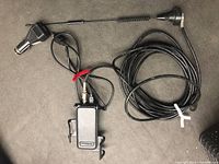 View of the full cell signal booster kit showing antenna, control box, cables, and car charger plug.