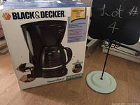 Photo of the Black & Decker SmartBrew coffee maker in its box, showing model details and product image on packaging.