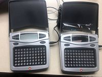 Front view of two Apollo Go Lite light therapy devices, showing LED light grids, display screens, and buttons.