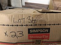 Box labeled Simpson Strong-Tie with quantity 23 and lot number handwritten