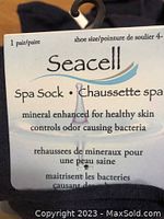 Close-up of Seacell brand tag describing spa socks as mineral enhanced for healthy skin and odor bacteria control, size fits shoe 4-7.