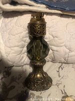 Vintage desk lighter with heavy decorative metal base, faceted glass midsection, and brass lighter mechanism needing new flint.