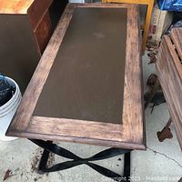 Top down view showing the rectangular coffee table with solid wood framed top and dark inset panel.