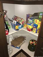 Photo showing multiple boxes of plastic wrap and freezer bags, several brands including Glad and Pantry Plus.