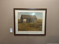 Framed print showing rustic barn and farming equipment, signed and numbered 99/150