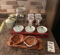 Overview showing all items in the lot including mugs in caddy, condiment jars, wooden bowls and trays
