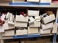Photo of labeled boxes on a shelf, showing baseball teams including Twins and Texans.