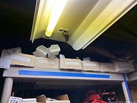 Boxes labeled Anaheim Angels and other MLB teams stored on a shelf.