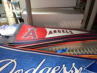 Close-up of a red Los Angeles Angels pennant and blue Los Angeles Dodgers pennant in a stack