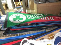 Stack of NBA basketball pennants showing Celtics and Bulls on top in felt material.