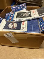 Box of multiple sealed vertical hanging flags with MLB branding visible on packaging.